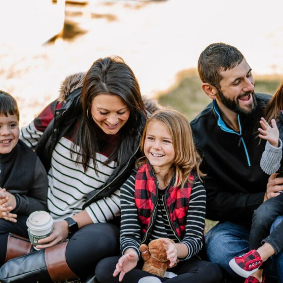 A family enjoys Christmas in Le Mars by sitting in a park