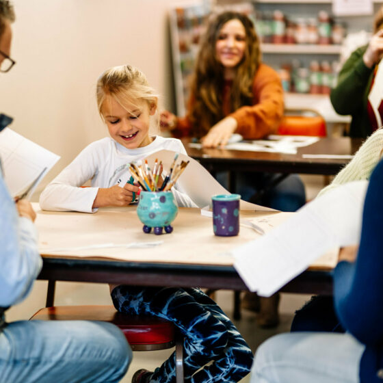 young girl sits and crafts during christmas at le mars